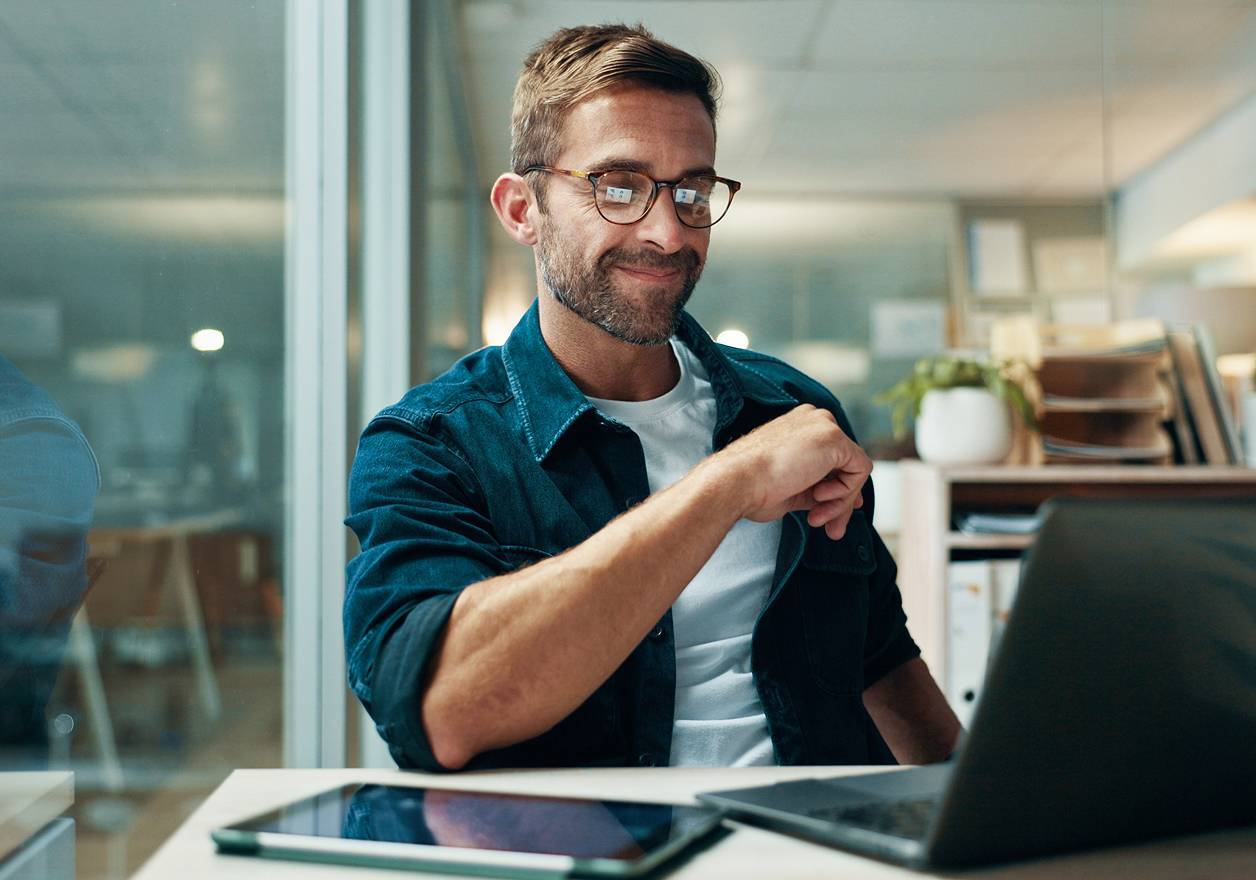 Businessman thinking and laptop in office with night